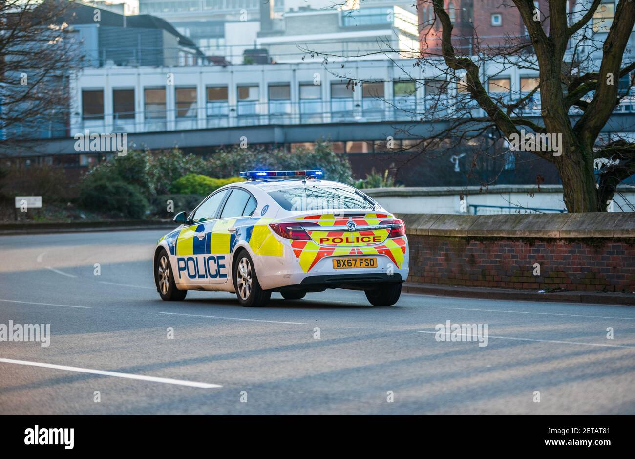 West Midlands Police Vauxhall Insignia on blue lights in Birmingham city centre around Lancaster Circus Stock Photo