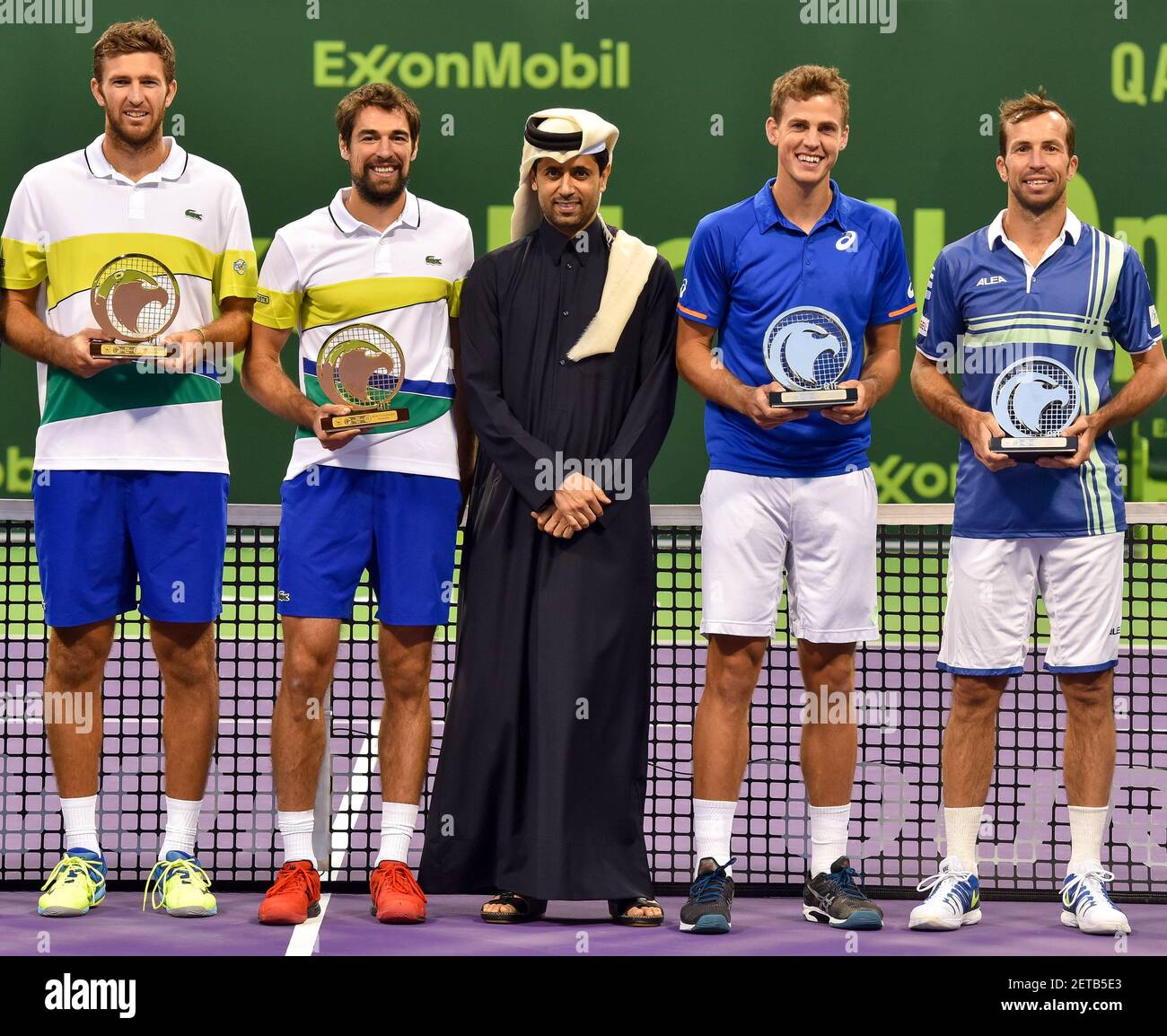 Fabrice Martin (L) and Jeremy Cardy (2-L)of Feance hold their trophies next  to a President Of The Qatar Tennis Federation Nasser Al-Khelaifi (C) at the  end of their men's doubles final match