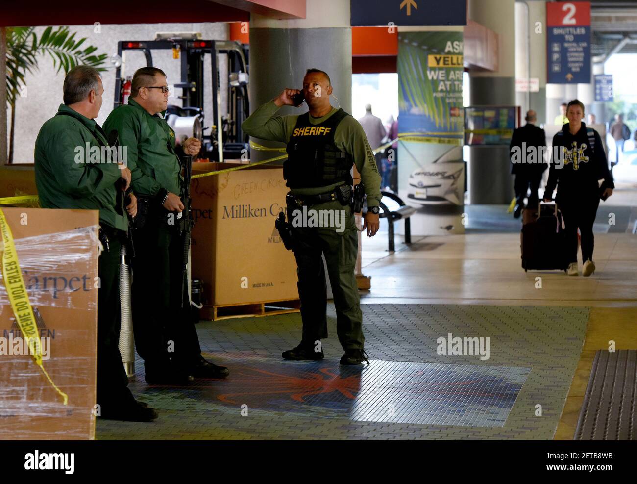 Broward Sheriff's Office officers stand guard outside the entrance to