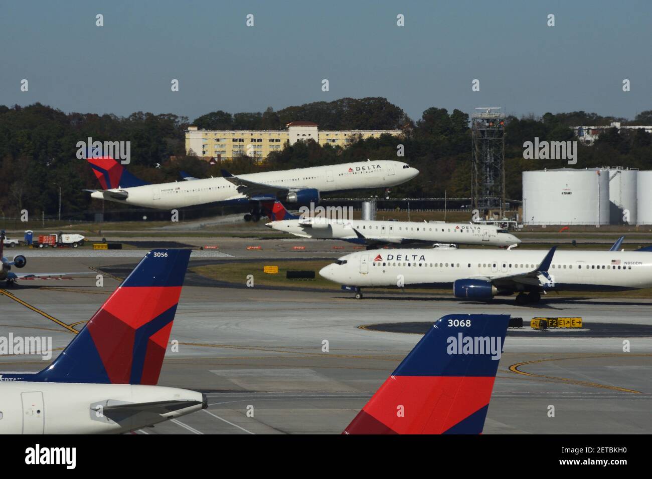 Delta Airlines airplane taking off and other airport traffic at the Hartsfield–Jackson Atlanta International Airport, the busiest airport in America. Stock Photo