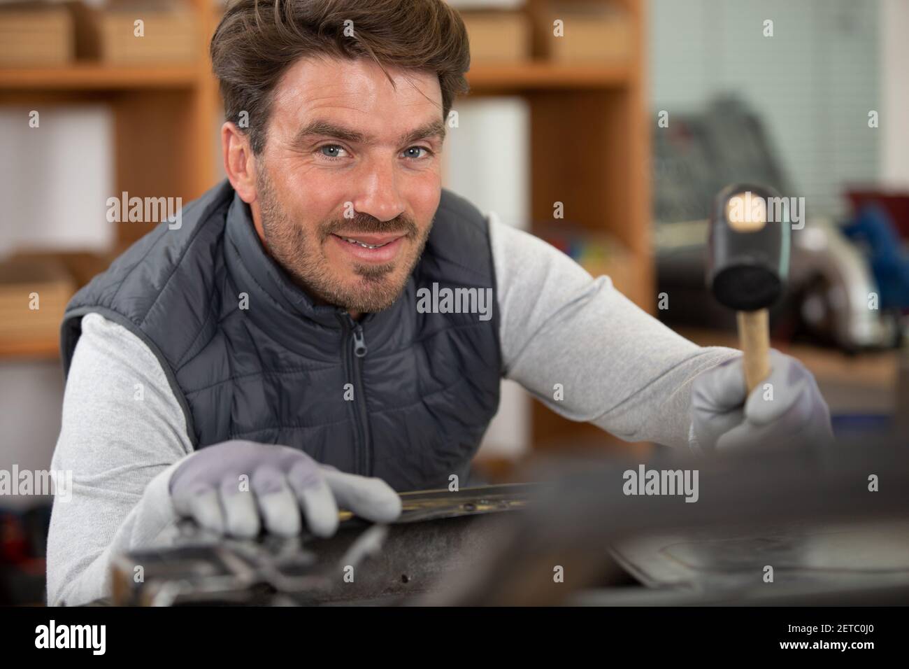 mechanic engineer using a hammer Stock Photo Alamy