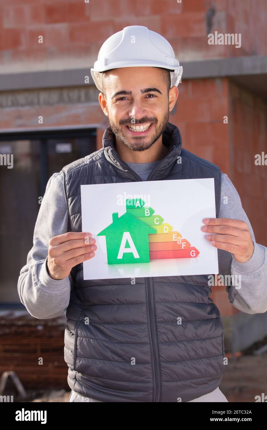builder holding energy consumption board Stock Photo