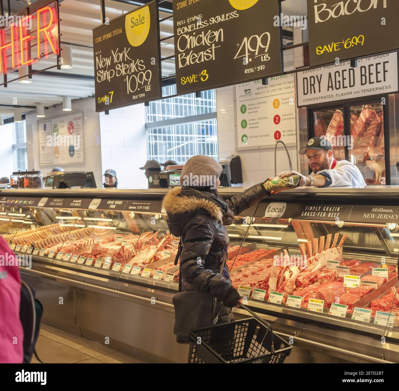 https://c8.alamy.com/comp/2ETD28T/a-shopper-chooses-cuts-of-meat-in-the-new-whole-foods-market-opposite-bryant-park-in-new-york-on-opening-day-saturday-january-28-2017-the-store-in-midtown-manhattan-is-the-chains-11th-store-to-open-in-the-city-the-store-has-a-large-selection-of-prepared-foods-from-a-diverse-group-of-vendors-inside-the-store-photo-by-richard-b-levine-please-use-credit-from-credit-field-2ETD28T.jpg