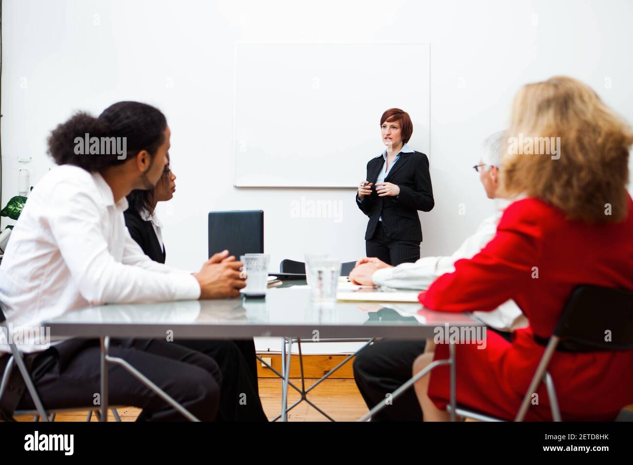 Woman giving a presentation with a white board. Stock Photo