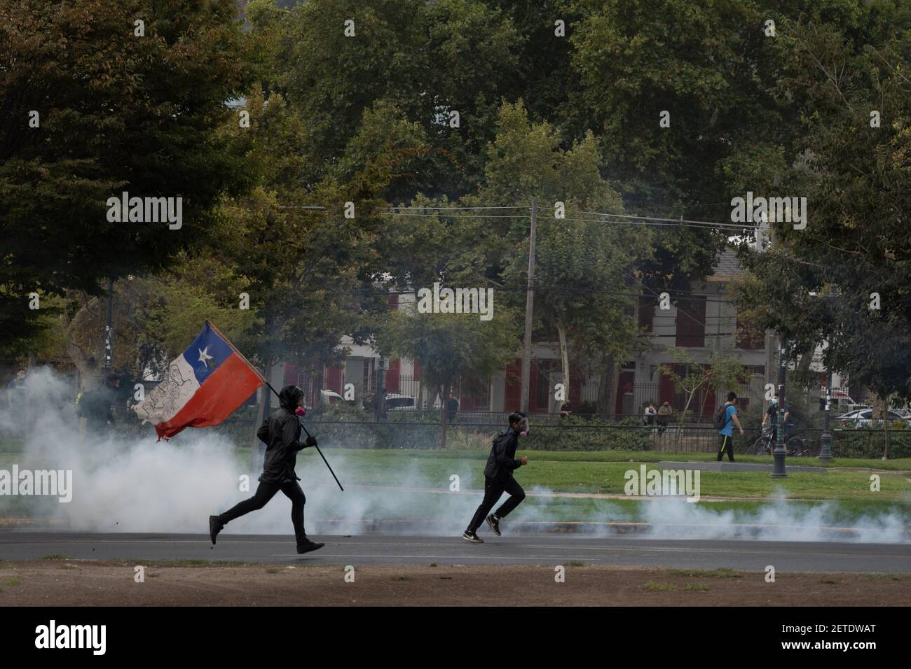 Santiago, Metropolitana, Chile. 1st Mar, 2021. Protesters rush to confront the police, after the police have thrown tear gas bombs. This protest was called by the students, as a day of student mobilization. Credit: Matias Basualdo/ZUMA Wire/Alamy Live News Stock Photo