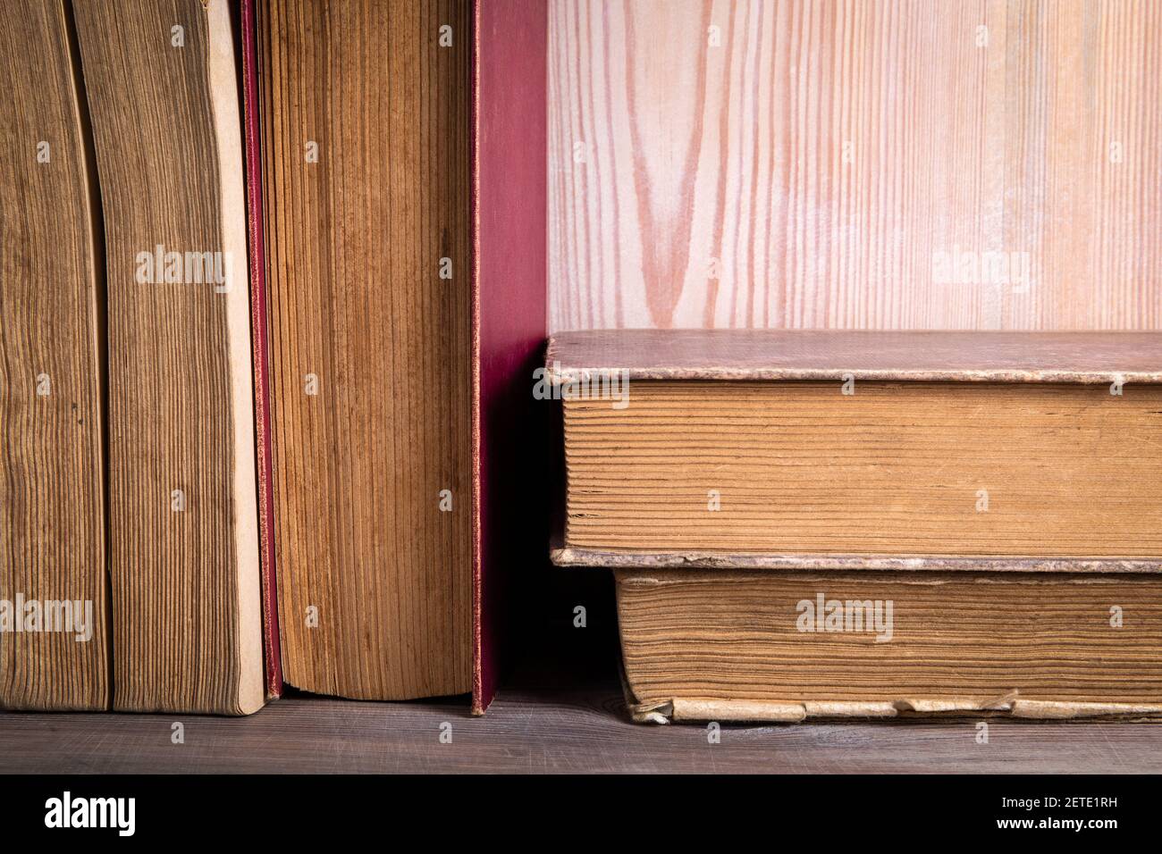Stack of old antique books. Wooden shelf. Stock Photo