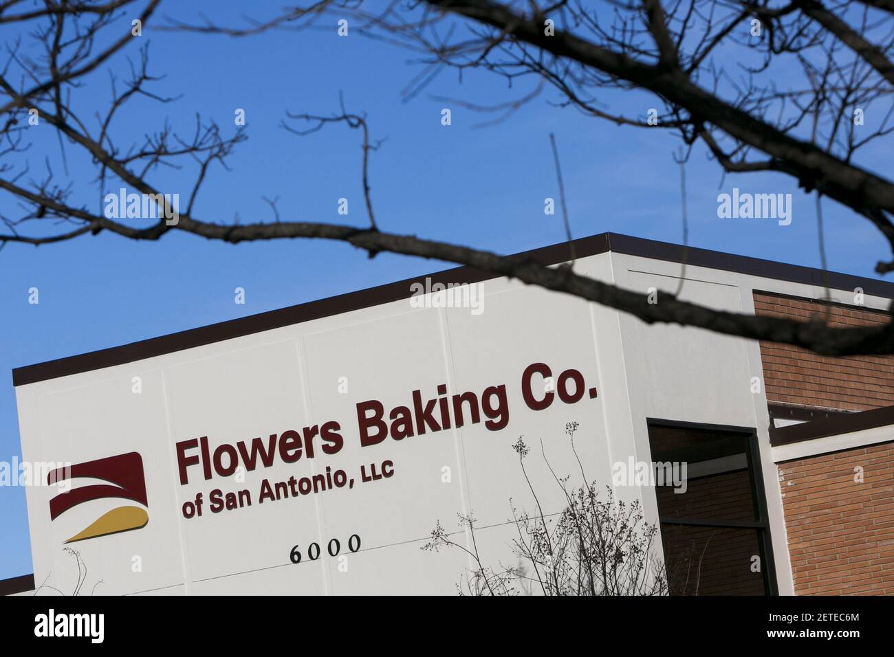 A logo sign outside of a facility occupied by the Flowers Baking