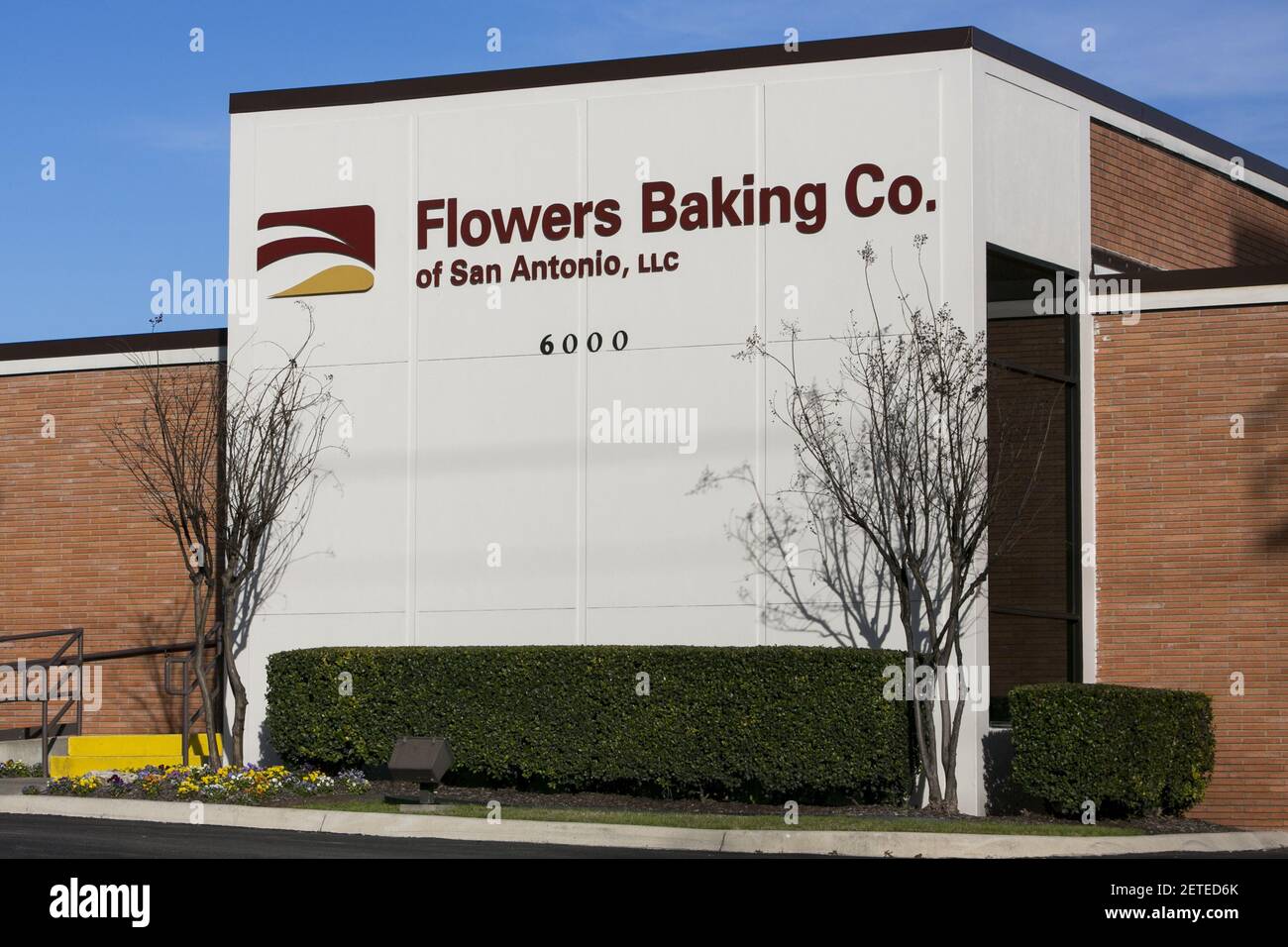 A logo sign outside of a facility occupied by the Flowers Baking