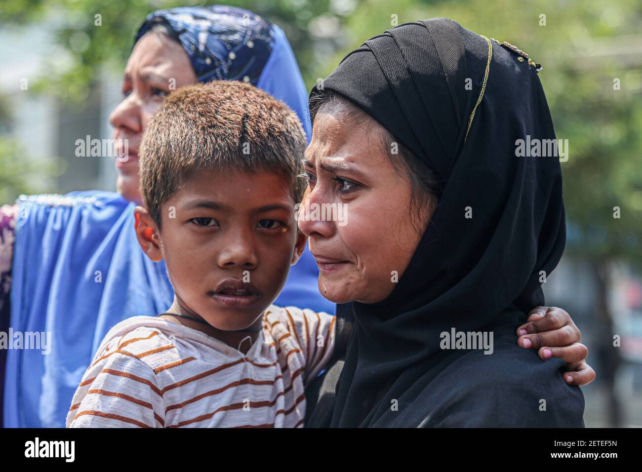 A woman is seen carrying a young girl and mourning the death of Daw Dasi  who was shot dead by the Myanmar Security Forces on February 28.Myanmar  Security Forces fire rubber bullets,