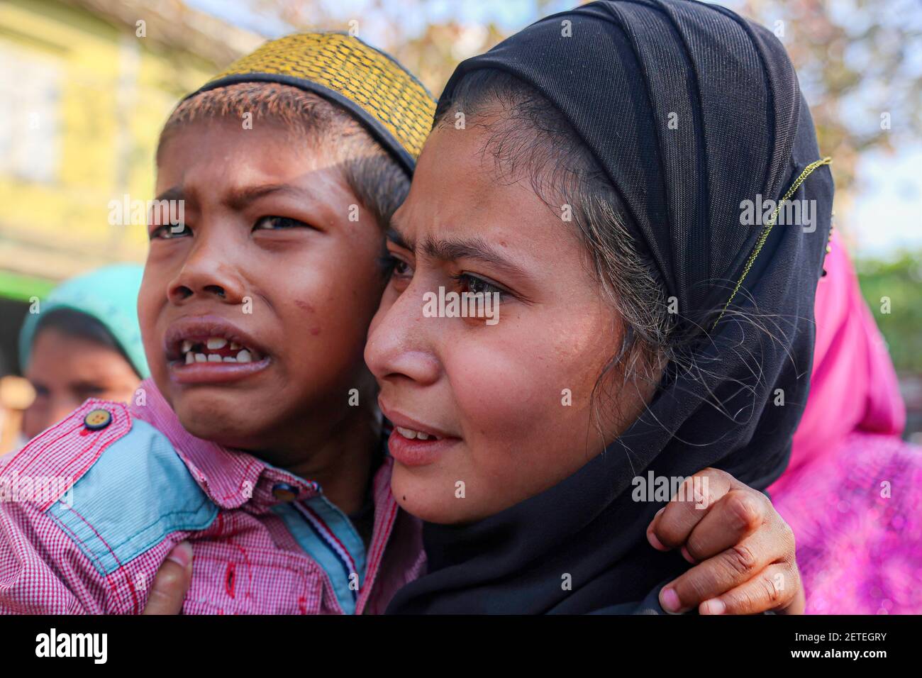 A woman and a child are seen crying at the funeral of Daw Dasi who was shot  dead by the Myanmar Security Forces on February 28.Myanmar Security Forces  fire rubber bullets, real