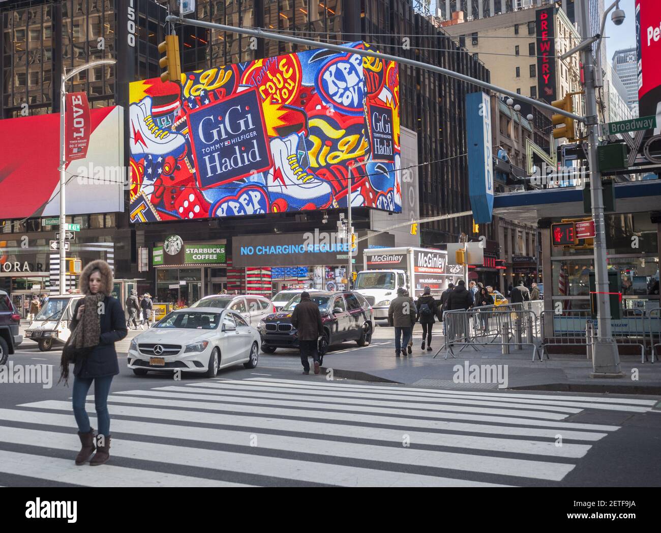 Pedestrians cross Broadway in Times Square in New York on Thursday,  February 16, 2017 in front of an advertisement for the Tommy Hilfiger/Gigi  Hadid collaboration. Hilfiger did not show at this year's