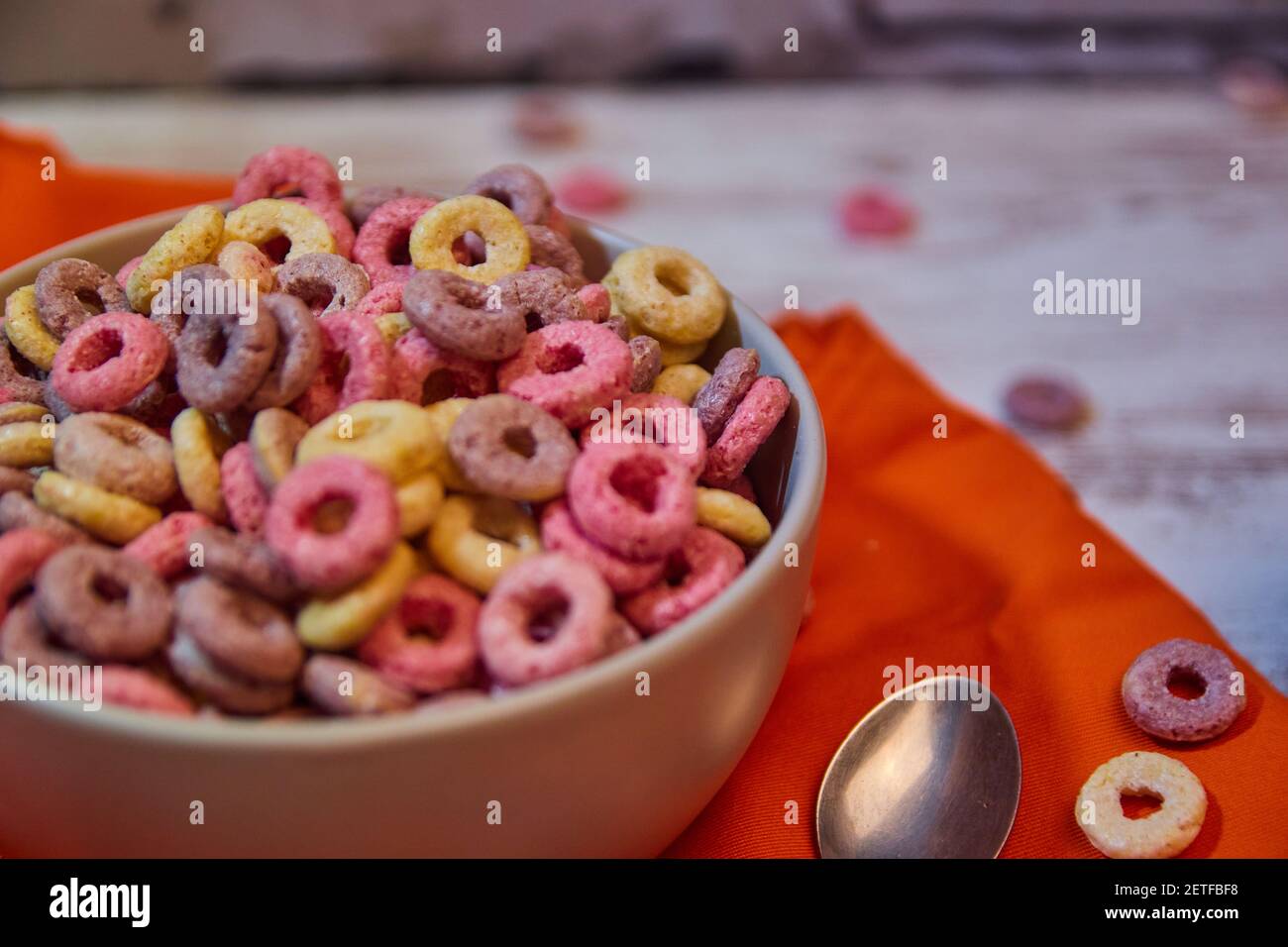 bad breakfast of colorful cereals full of sugar with red fruit juice