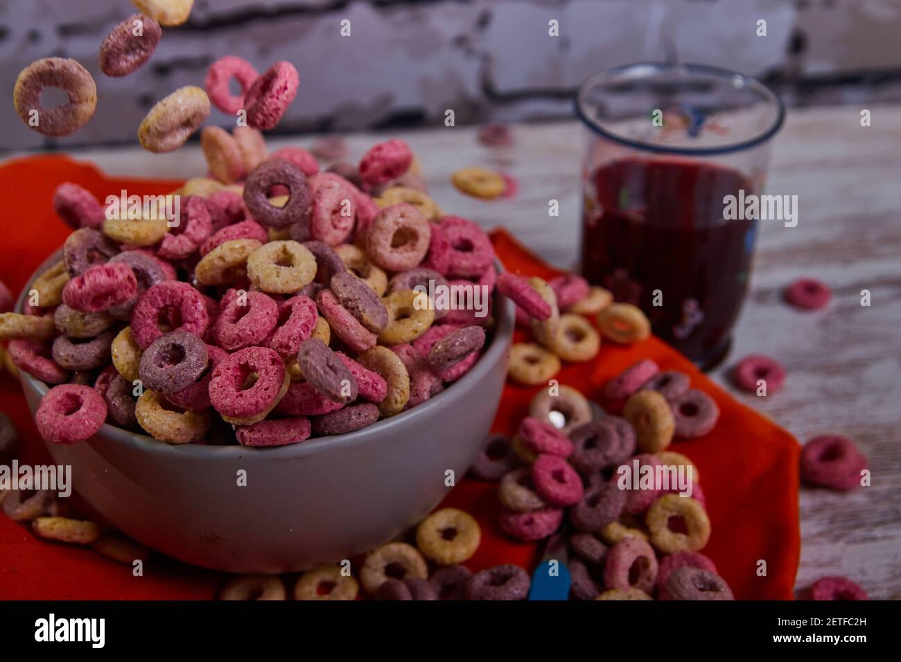 bad breakfast of colorful cereals full of sugar with red fruit juice Stock Photo Alamy