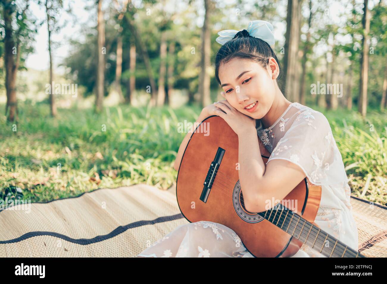 Girl hug guitar in the forest. Love Music hobby and picnic concept Stock  Photo - Alamy