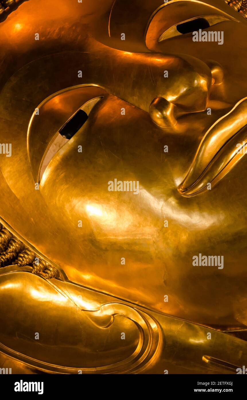 Face of the Golden Reclining Buddha Statue of Wat Pho Monastery in Bangkok of Thailand. Stock Photo