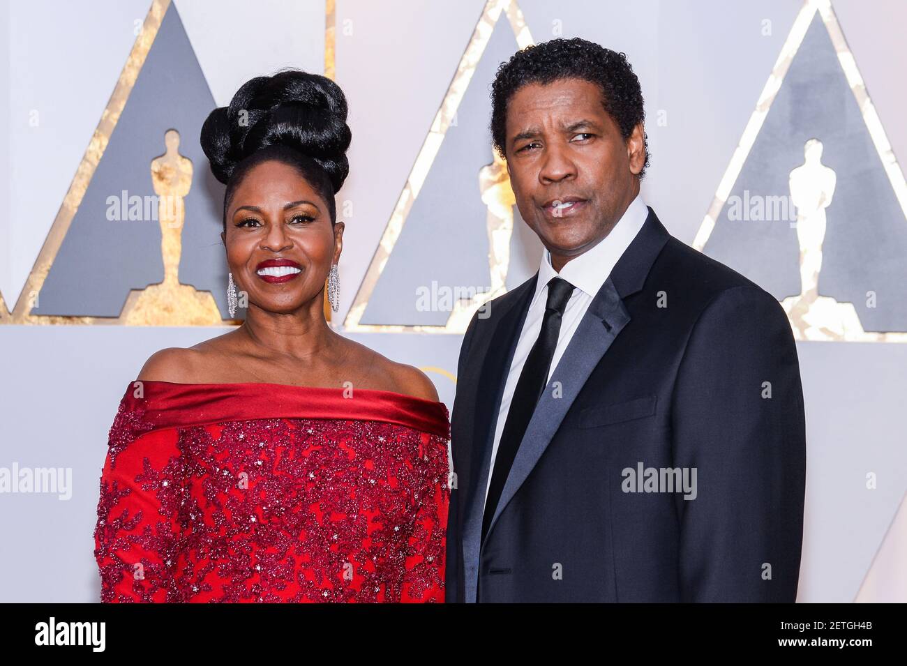 Pauletta Washington and Denzel Washington walking the red carpet during