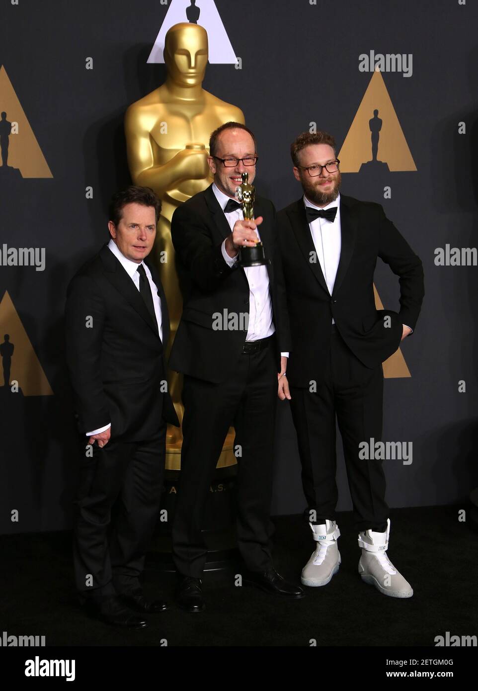 L R Actor Michael J Fox Editor John Gilbert Winner Of Best Film Editing For Hacksaw Ridge And Actor Seth Rogen Pose In The Press Room During The th Academy Awards Ceremony Presented
