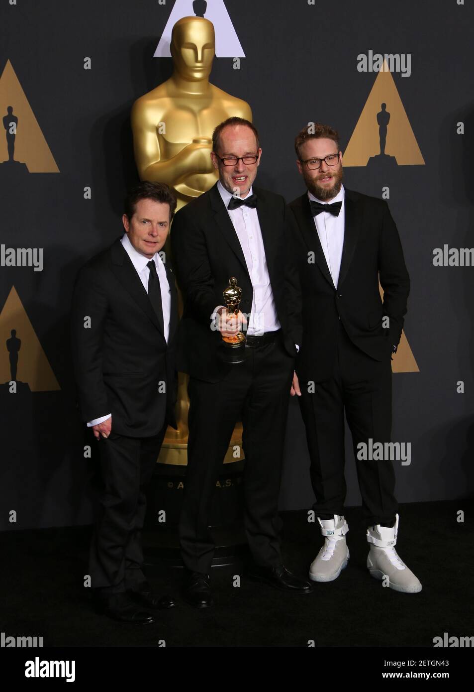 L R Actor Michael J Fox Editor John Gilbert Winner Of Best Film Editing For Hacksaw Ridge And Actor Seth Rogen Pose In The Press Room During The th Academy Awards Ceremony Presented