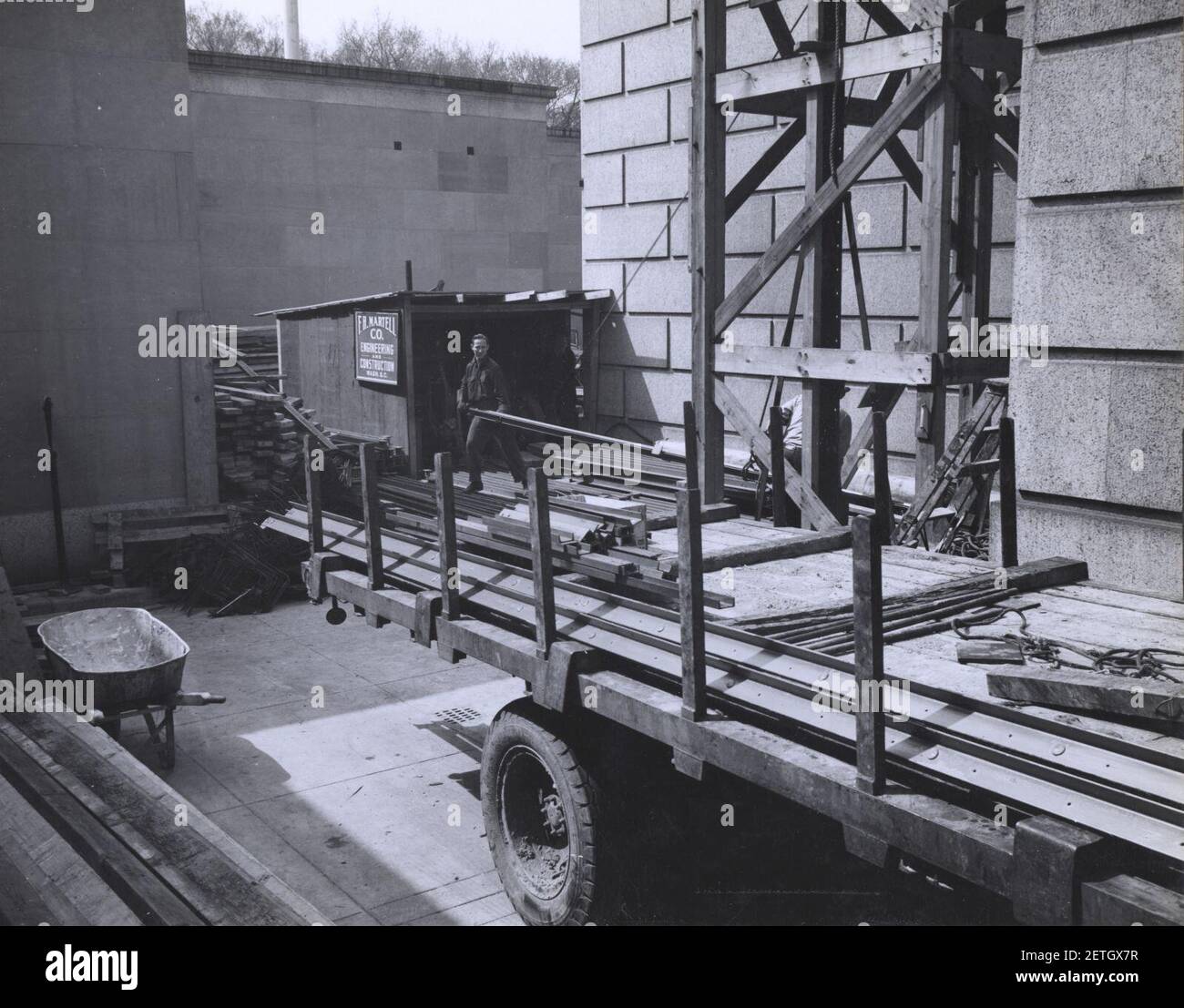 Photograph of Workers Unloading a Truck at the National Archives Building during Exterior Construction, Washington, D.C. Stock Photo