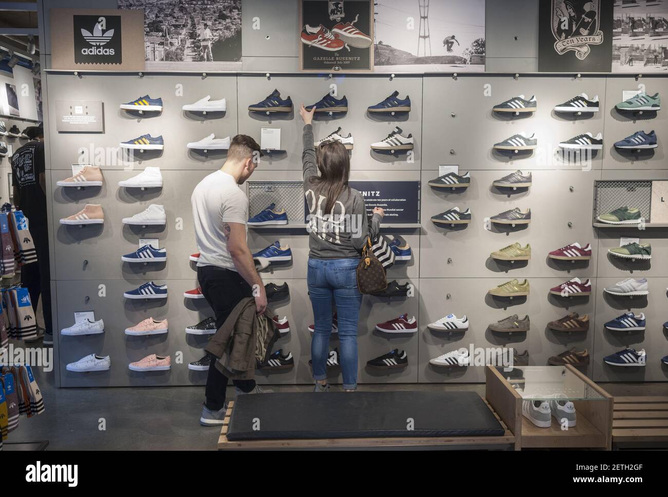 Customers browse footwear in the Adidas flagship store on Fifth Avenue in New  York on Tuesday, February 28, 2017. Consumer confidence is reported to be  at the highest level since July 2001.(Photo