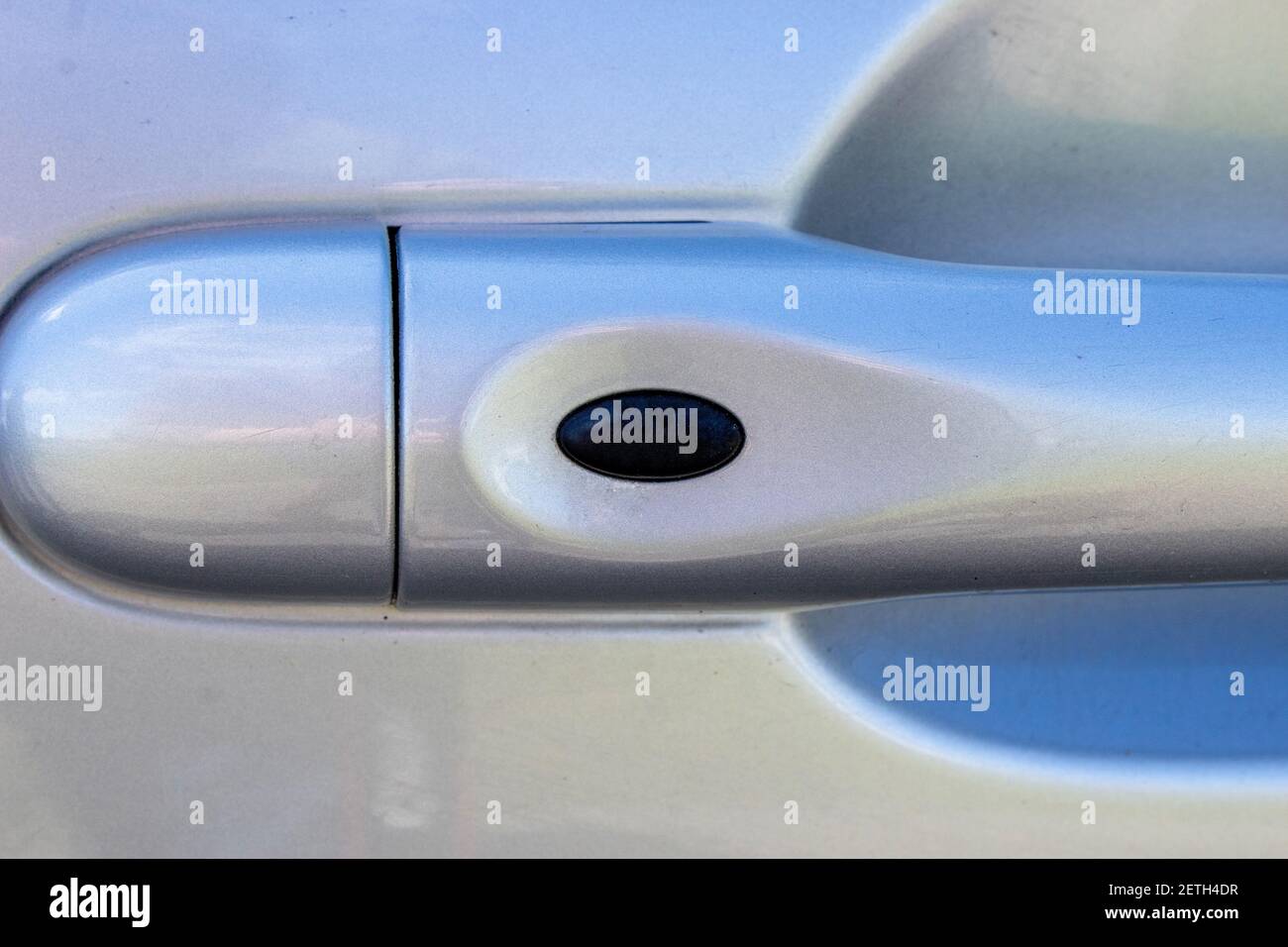 Handle the car with unlock button of the doors. The door handle of the