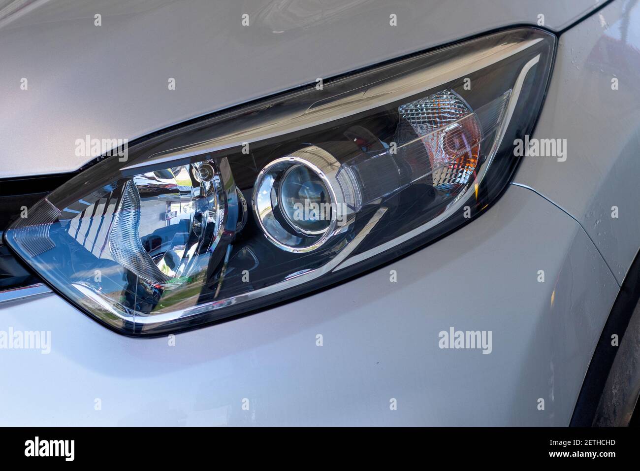 The front light of the car. Modern halogen lighting. Front lighting of a silver car Stock Photo
