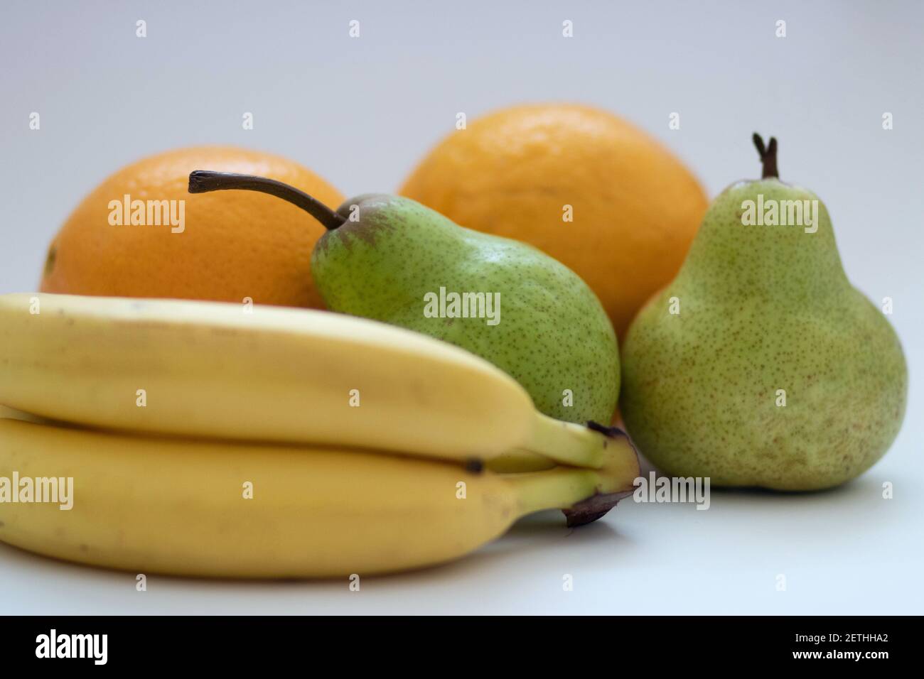 Oranges, pears and bananas on a white isolated background Stock Photo