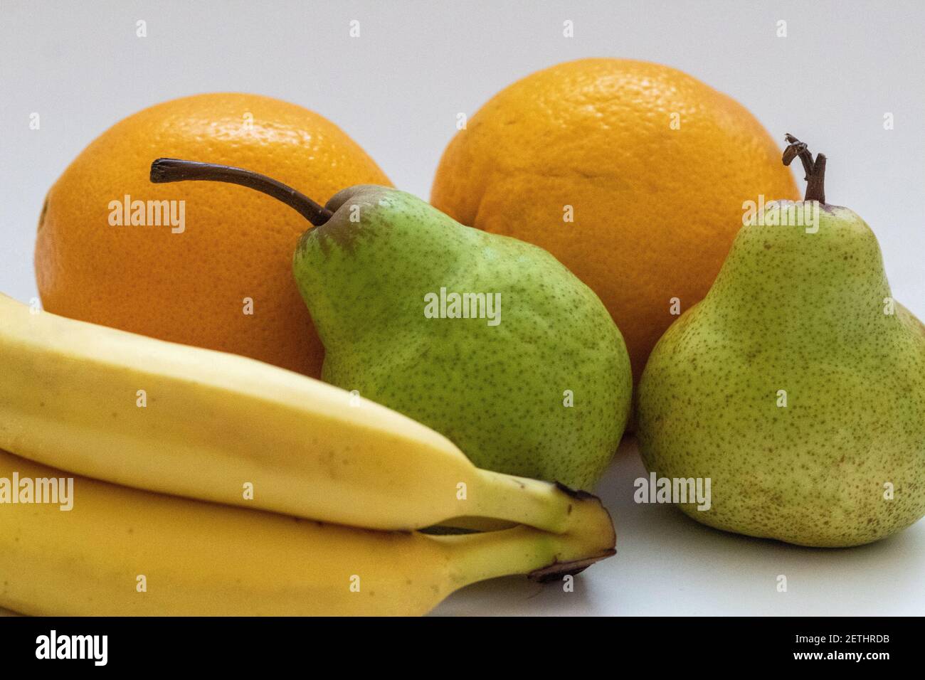 Oranges, pears and bananas on a white isolated background Stock Photo