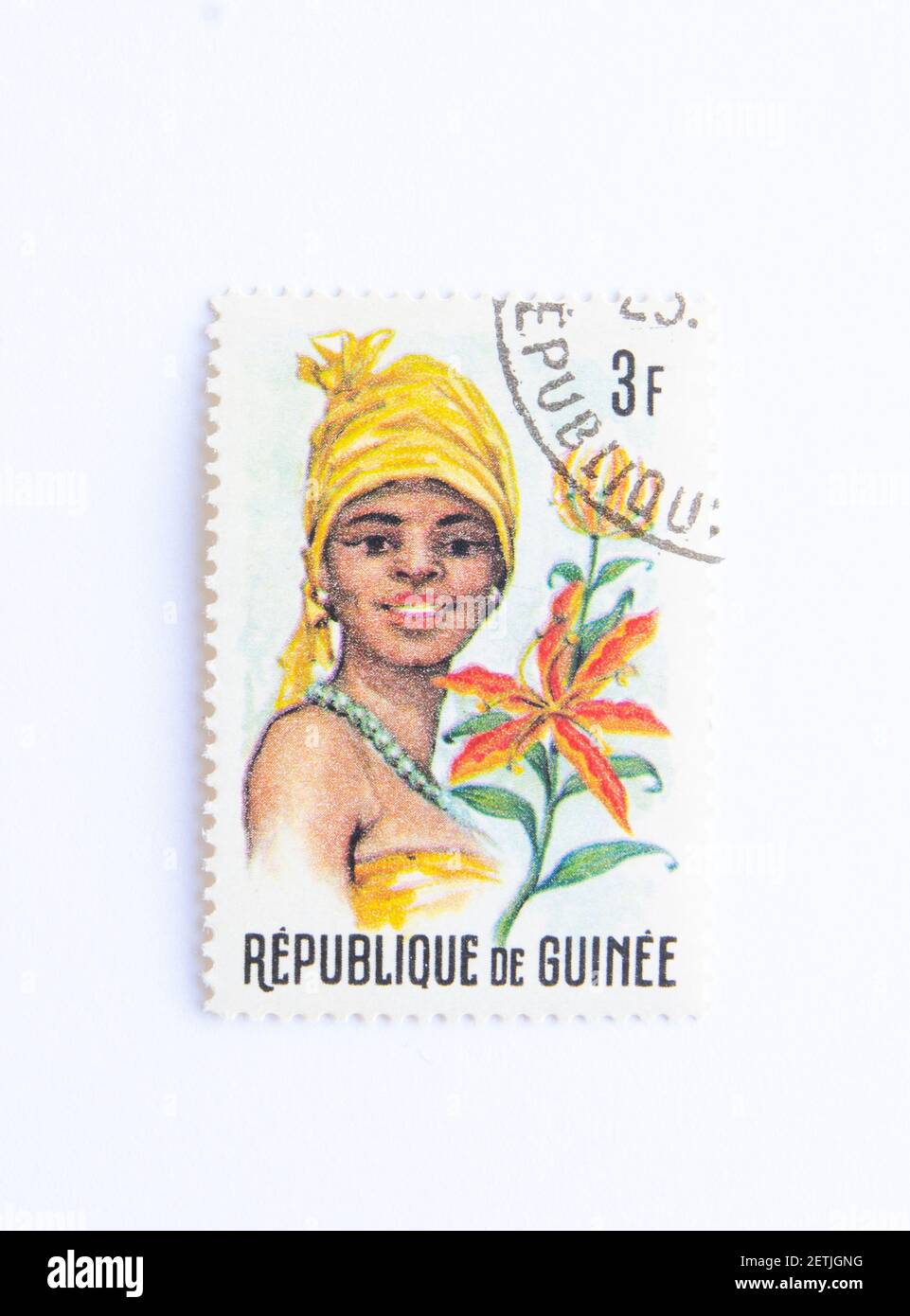 01.03.2021 Istanbul Turkey. Guinea Republic Postage Stamp. circa 1966.  'guinean flora and female headdresses ' Stock Photo