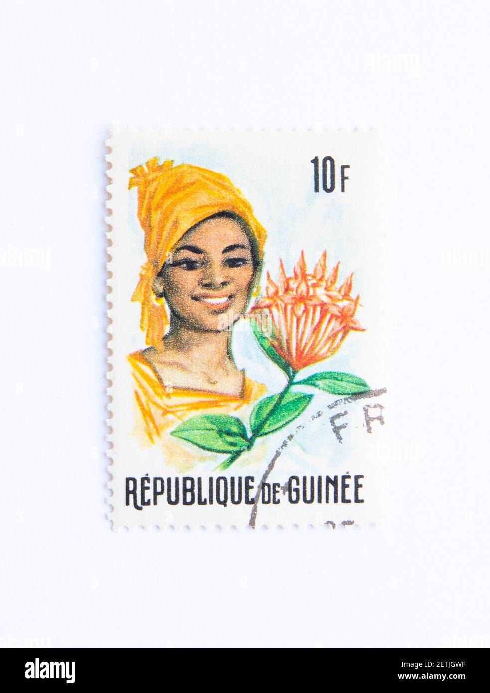 01.03.2021 Istanbul Turkey. Guinea Republic Postage Stamp. circa 1966.  'guinean flora and female headdresses ' Stock Photo