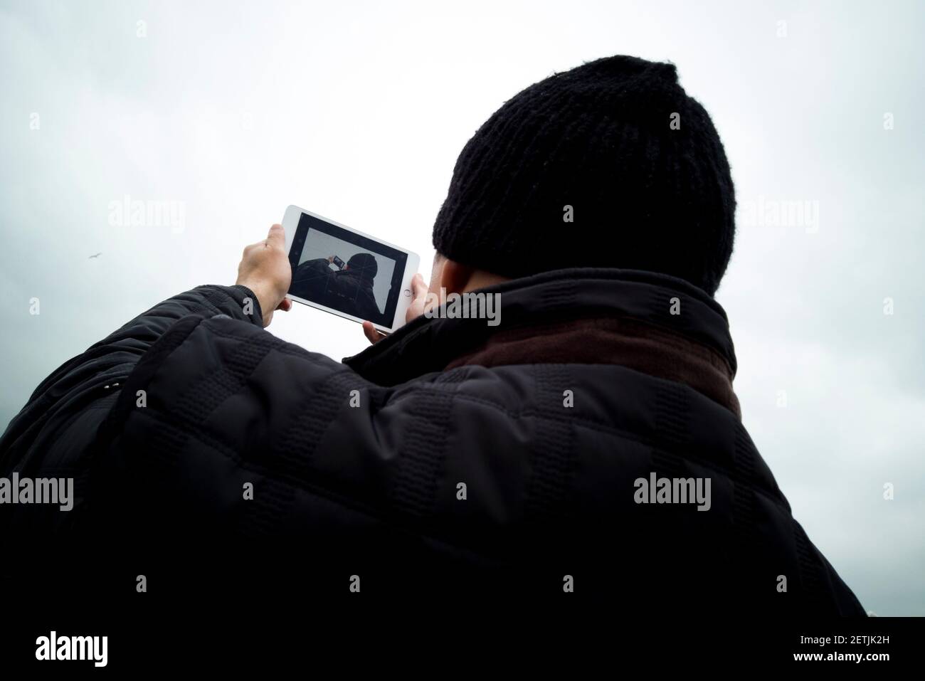 man holding tablet in foggy day outside shot Stock Photo