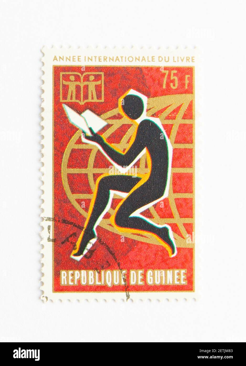 01.03.2021 Istanbul Turkey. Guinea Republic Postage Stamp. circa 1972. international year of the book. man reading book Stock Photo