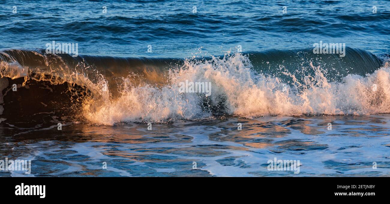Splashing waves on the beach Stock Photo