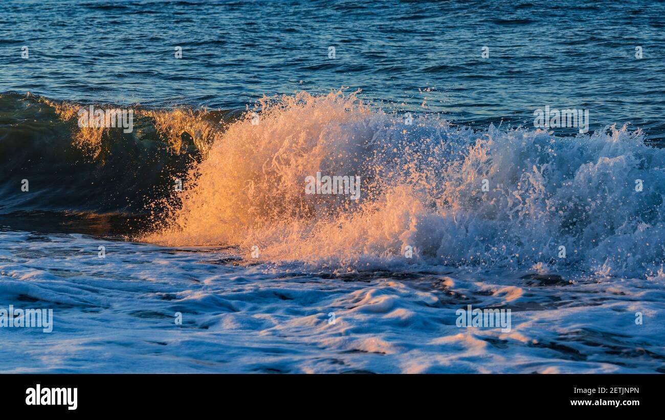 Splashing waves on the beach Stock Photo