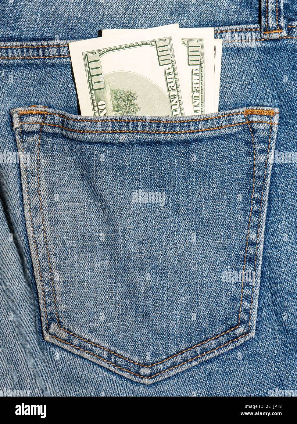 one hundred US dollars in the back pocket of jeans Stock Photo