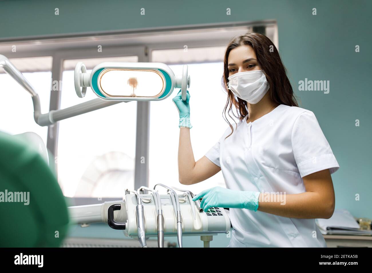 Young female dentist in white coat at workplace Stock Photo Alamy