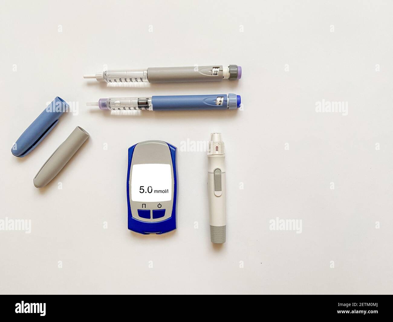Insulin short, long, glucose meter, test strips and finger piercing pen on a white isolated background. Set for diabetics with mock up Stock Photo