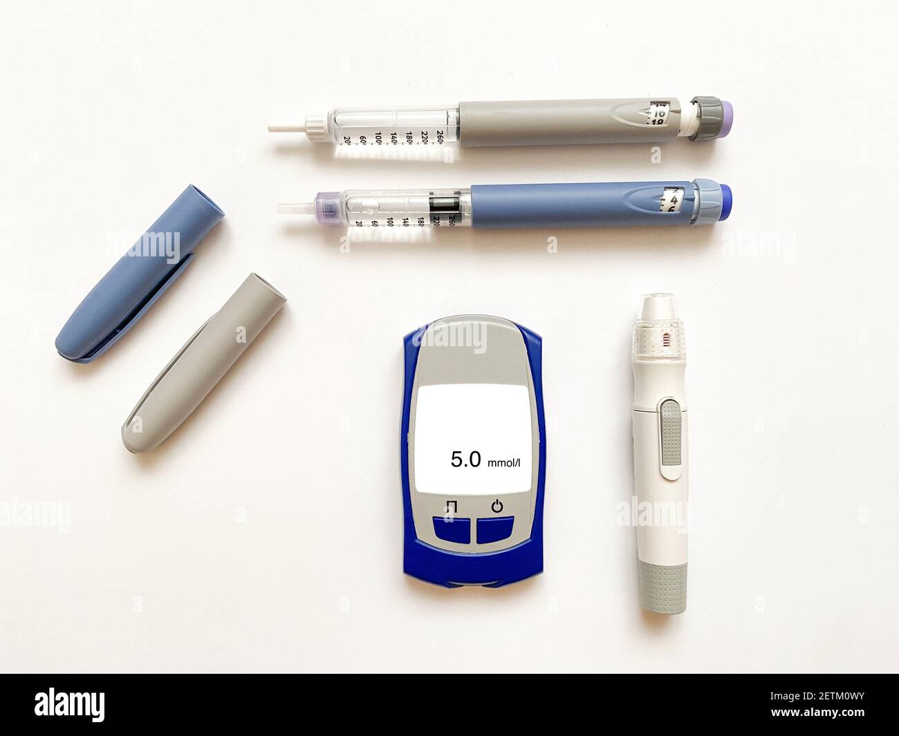 Insulin short, long, glucose meter, test strips and finger piercing pen on a white isolated background. Set for diabetics with mock up Stock Photo