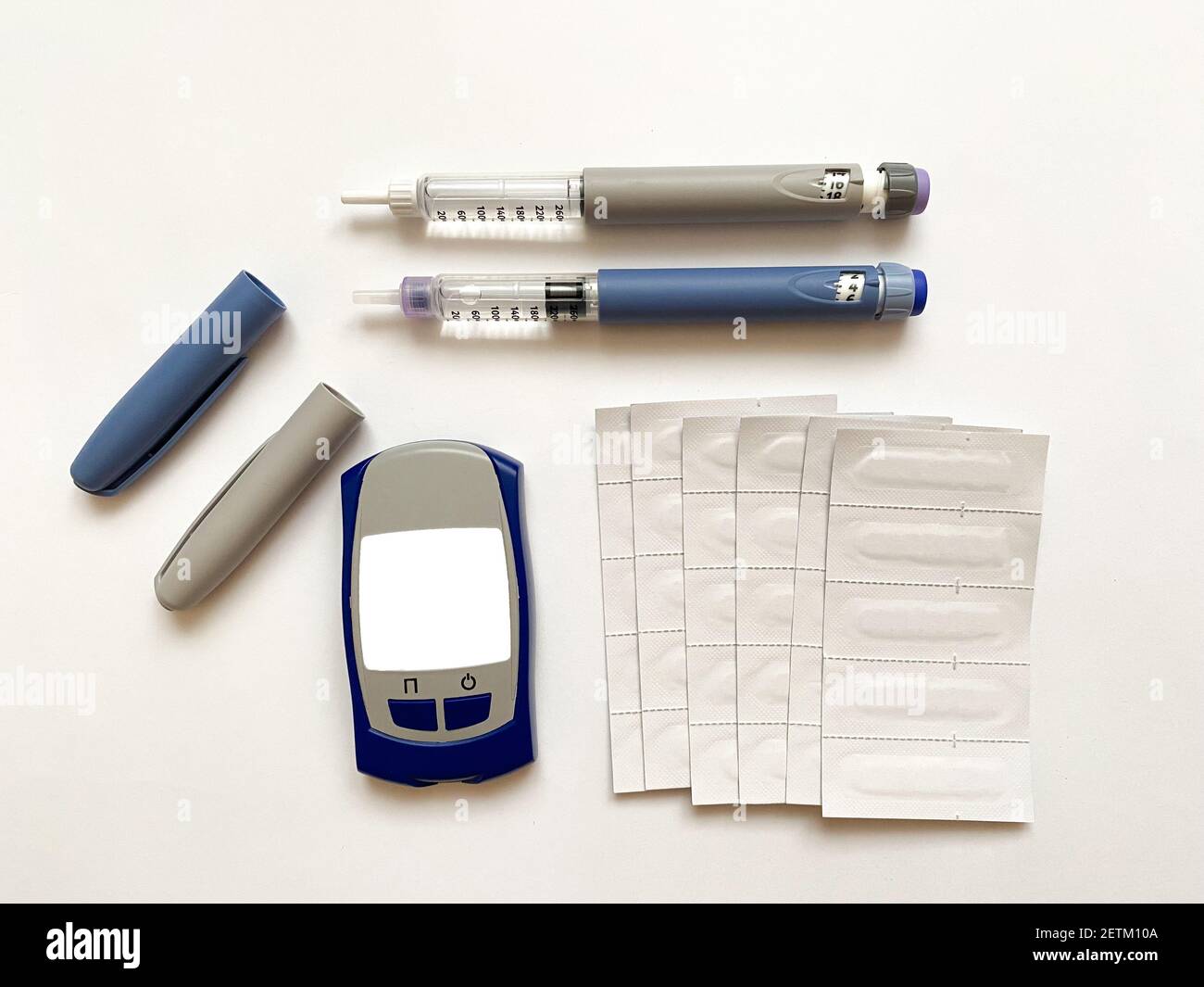 Insulin short, long, glucose meter and test strips on a white isolated
