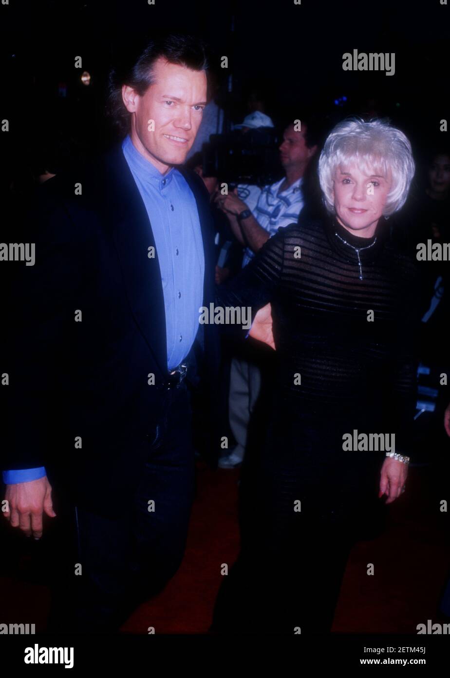 Westwood, California, USA 8th May 1996 Singer Randy Travis and Elizabeth Hatcher-Travis attend Warner Bros. Pictures 'Twister' Premiere on May 8, 1996 Village in Westwood, California, USA. by