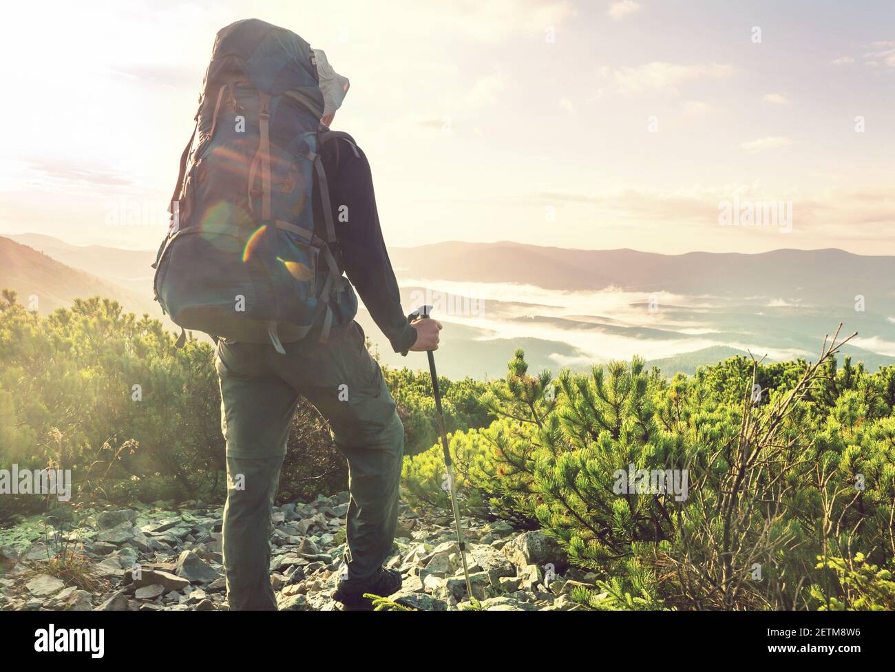 Spring Hike Man Man in a hike in the summer mountains. Beautiful natural landscapes ...