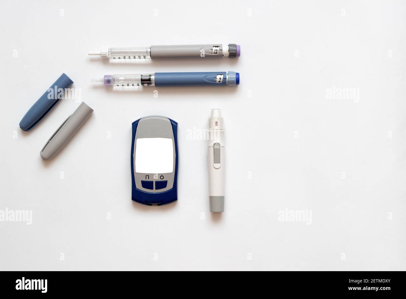 Insulin short, long, glucose meter, test strips and finger piercing pen on a white isolated background. Set for diabetics with mock up Stock Photo