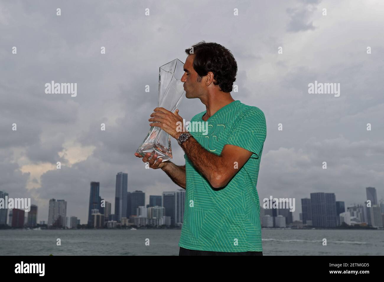 Apr 2, 2017; Key Biscayne, FL, USA; Roger Federer of Switzerland poses for  a champion's portrait with the Butch Buchholz Trophy in front of the Miami  skyline after his match against Rafael