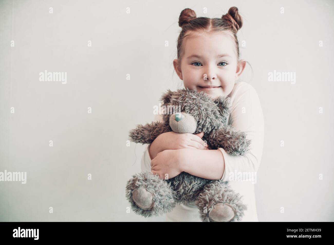 Sad little girl standing with bear. High quality photo Stock Photo