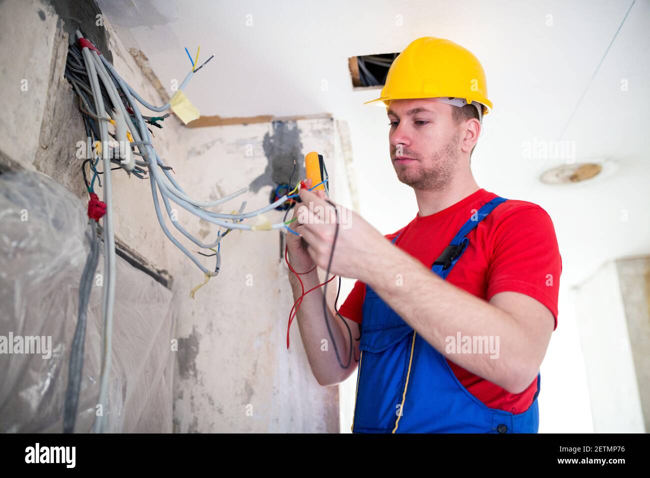 Electric cables connection verifying with unimer performed by a skilled operative Stock Photo