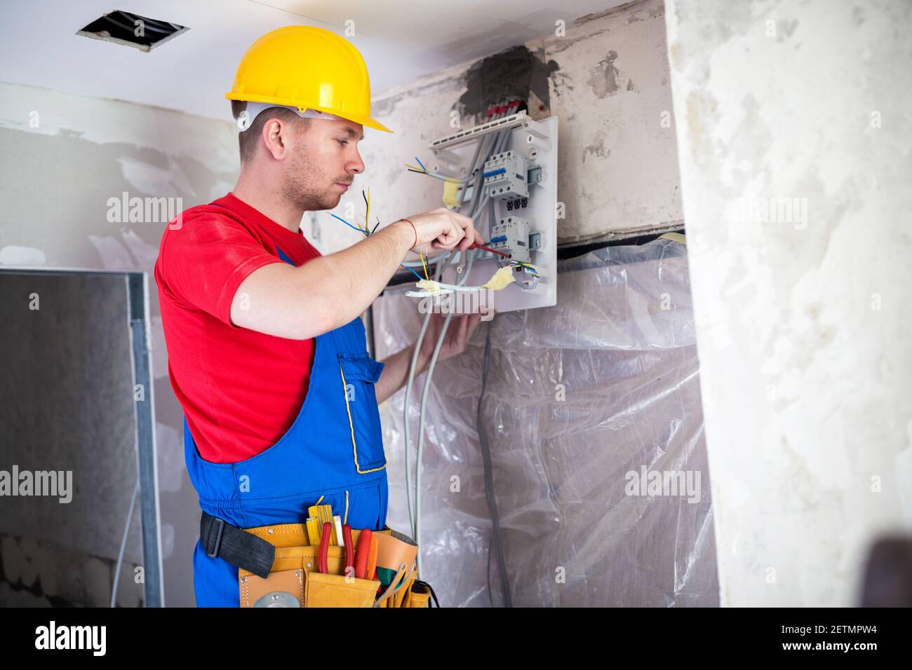 Applying automatic switches on distribution board with standard screwdriver Stock Photo