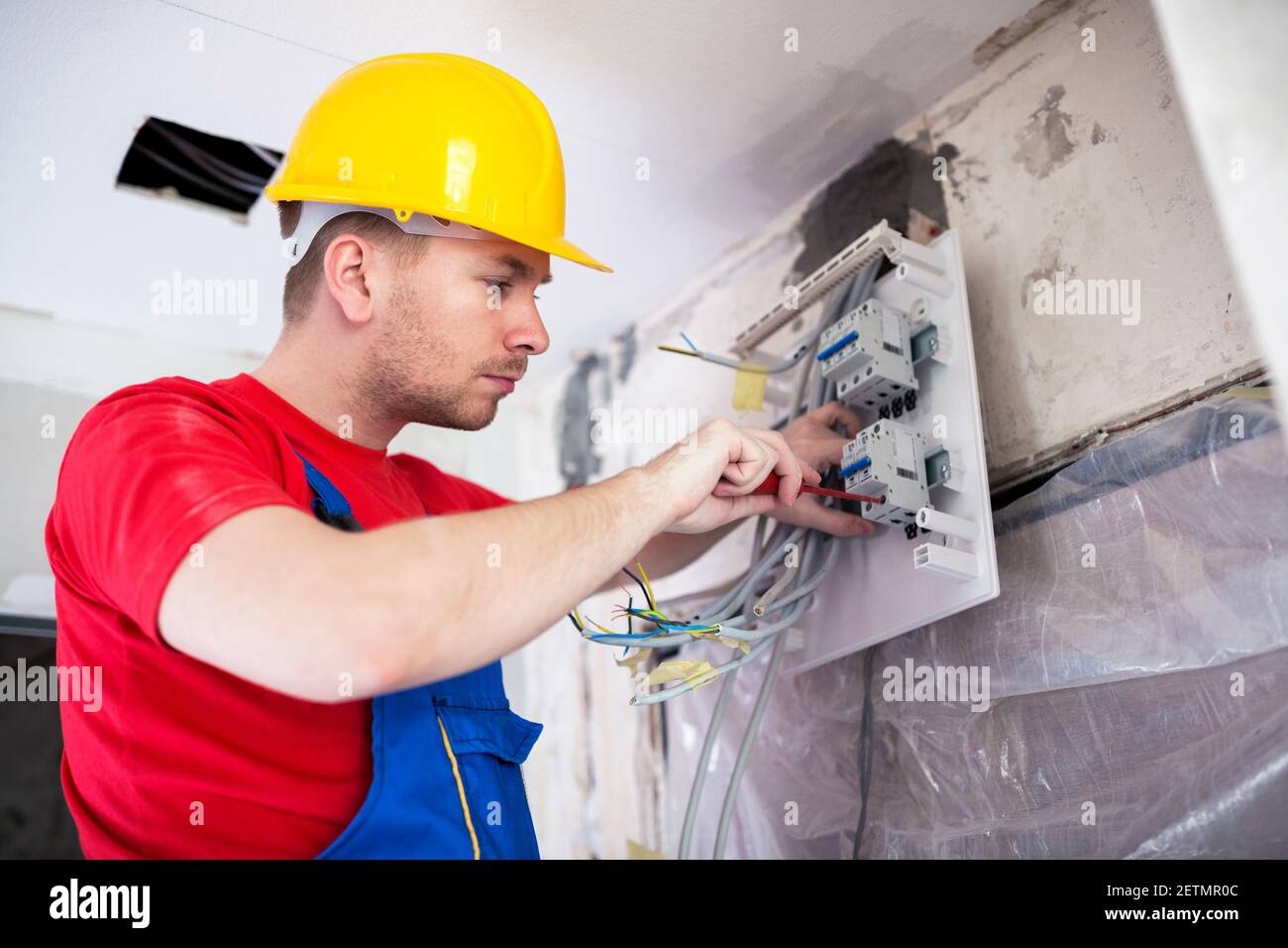 Applying automatic switches on distribution board with standard screwdriver Stock Photo