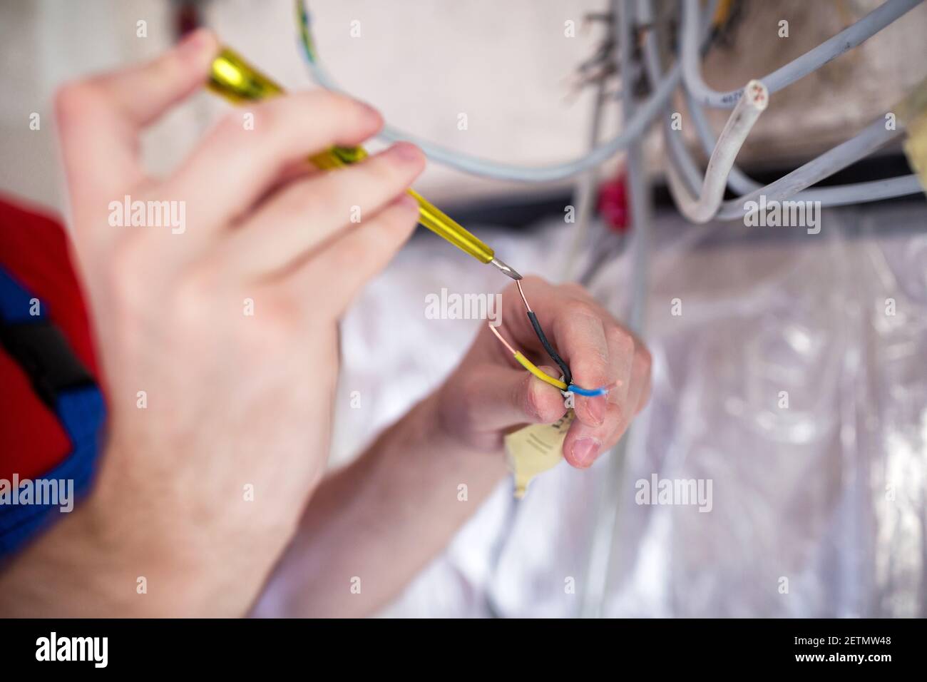 Handyman doing voltage checking with insulated screwdriver Stock Photo