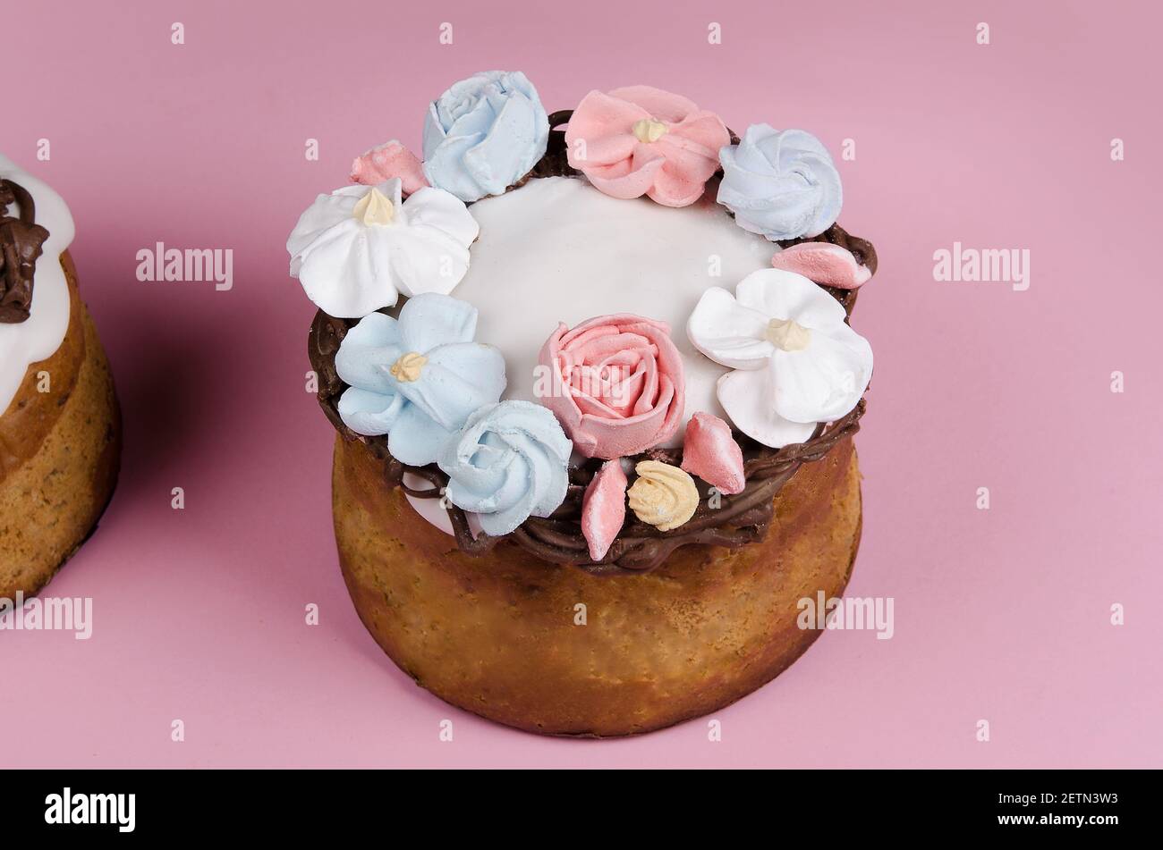 Festive Easter cake with flower decorations on pink background Stock Photo