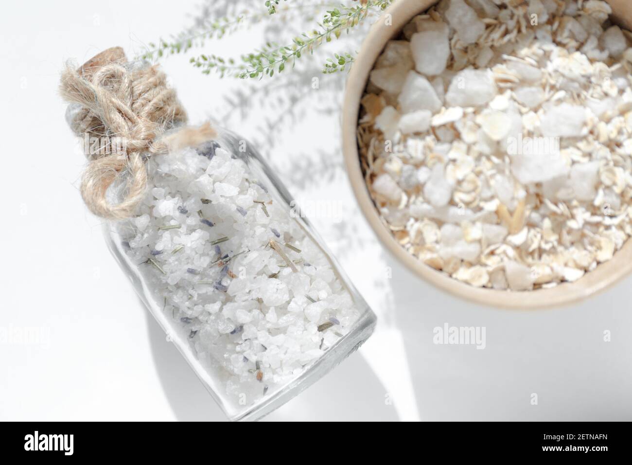 Sea salt in a glass jar with a cork stopper. Spa massage products of skincare on a white background. Close-up details Stock Photo